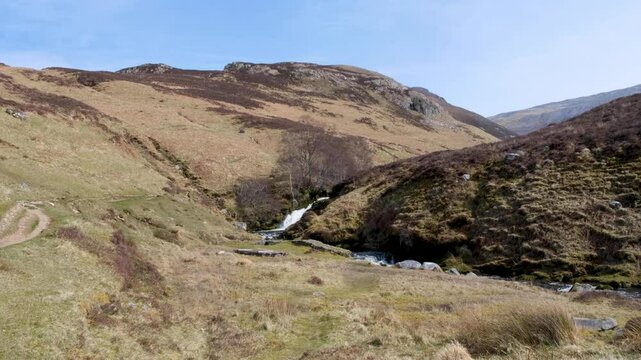 Scenic Scottish countryside view of river and waterfall at Bone Caves in Inchnadamph, Sutherlands highlands of Scotland UK