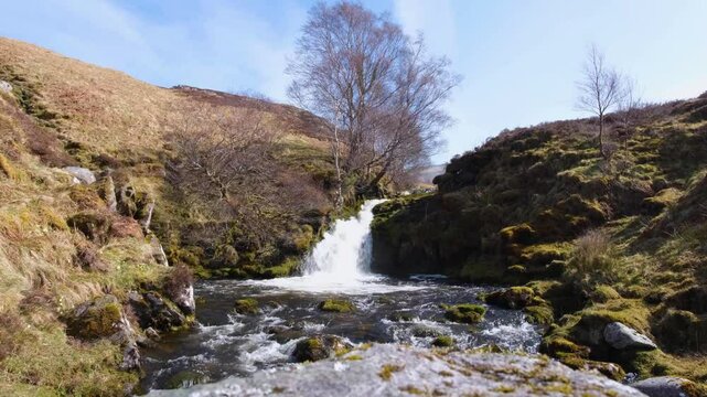 Scottish rural countryside with fast flowing waterfall river at Bone Caves of Inchnadamph in Sutherlands highlands of Scotland UK