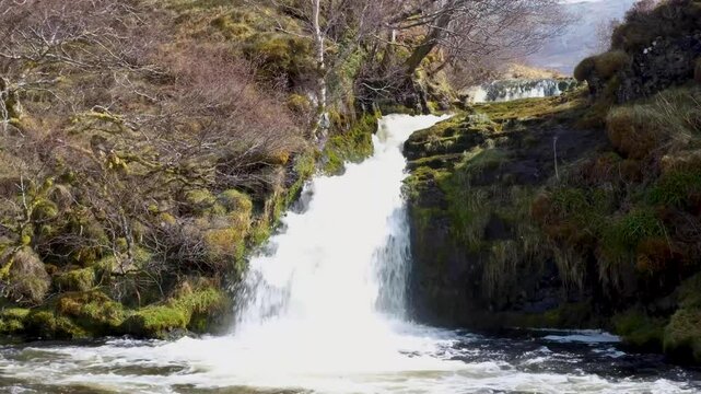 Scenic view of fast flowing whitewash waterfall and river in Sutherlands highlands of Scotland UK