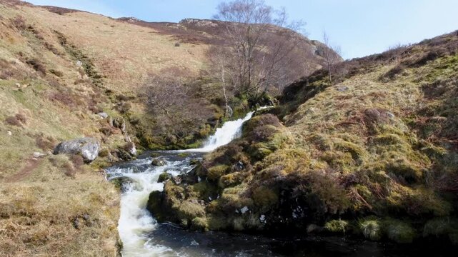 Scenic rural countryside Scottish view of idyllic waterfall and river in Sutherlands highlands of Scotland UK