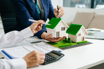 balancing the property sector The real estate agent is explaining the house style to see the house design