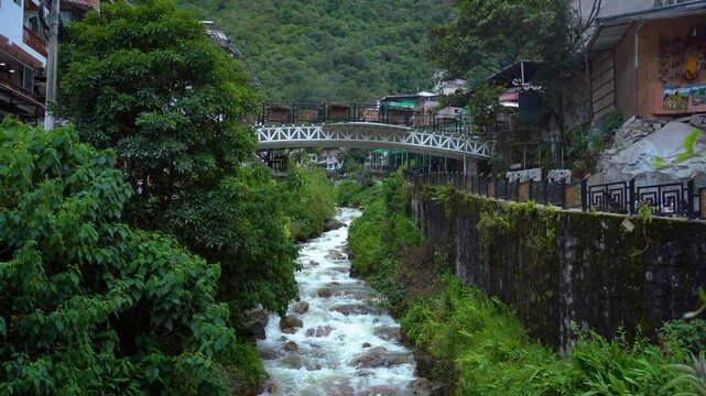 Aguas Calientes River Flowing Under Railway Bridge with Multiple Bridges in the Distance