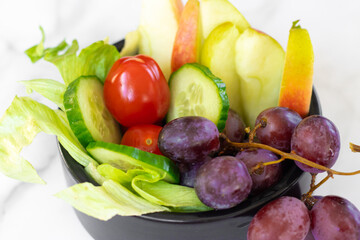 A plate with a variety of fresh fruits and vegetables, rich in vitamins. Healthy lifestyle, proper nutrition, balanced diet, organic food, vegan, nutritious, and vibrant.