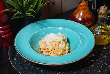 Fresh tagliatelle pasta topped with parmesan.