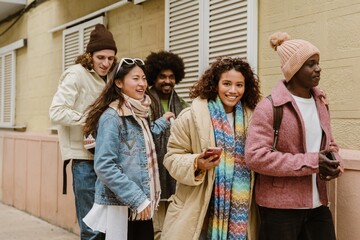 A group of friends gathered for a walk down the street, sharing laughter and conversation. A concept of friendship, lightheartedness, time spent together, and bonding.