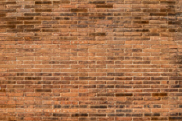 Brick wall with varied tones, creating a textured pattern. Warm hues and structured layout...