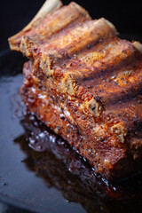Pork ribs on a cast-iron skillet.