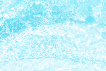 Blue water with ripples on the surface. Defocus blurred transparent blue colored clear calm water surface texture with splashes and bubbles. Water waves with shining pattern texture background.