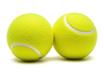 Two tennis balls sitting side by side on a white surface in a studio setting with bright lighting isolated on white background