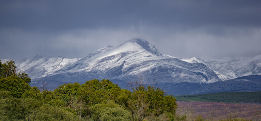 Imposing mountain peak covered with snow on a cloudy day