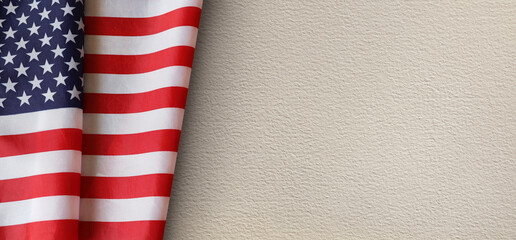 United States flag draped on a textured beige paper background. Symbolizing patriotism, freedom, and national pride. Perfect for memorials, holidays, or political themes with copy space.