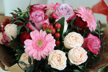 A beautiful bouquet of roses and gerberas in pink and red shades