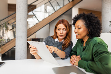 Two Professional Women Collaborating in a Modern Office Environment