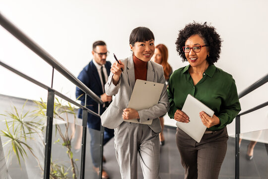 Professional Business Team Walking and Discussing in Modern Office Space
