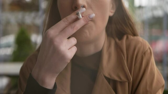 Young Caucasian Woman Smoking Cigarette. Close Up Female Lips Inhale Cigarette