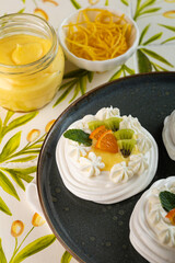 Macro of mini Fruit Pavlova with whipped cream and fresh toppings for a delightful dessert