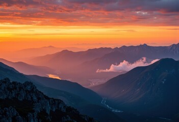 Fototapeta premium Breathtaking sunset over mountain ranges with vibrant colors and clouds