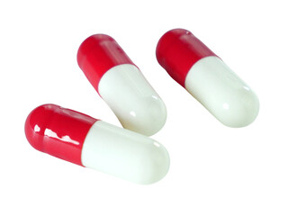 Bulk red and white capsule pills isolated on white background.