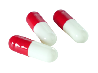 Bulk red and white capsule pills isolated on white background.