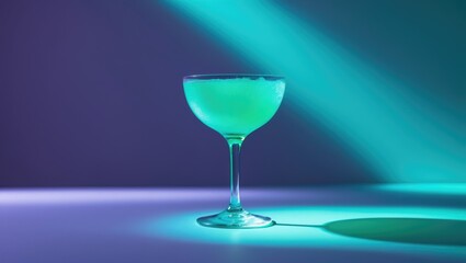 Fluorescent Halloween cocktail aesthetic with vibrant teal green drink and purple background.