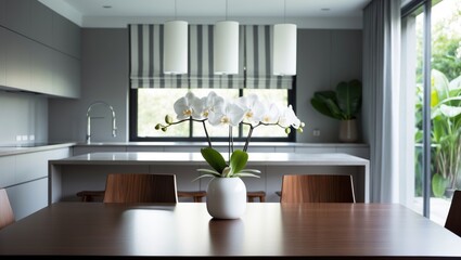 Table and wooden chairs in a dining zone with a decorative roller blind on the window