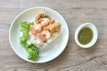 grilled shell out river shrimp dredding crab fat on rice in plate dipping spicy Thai seafood sauce 