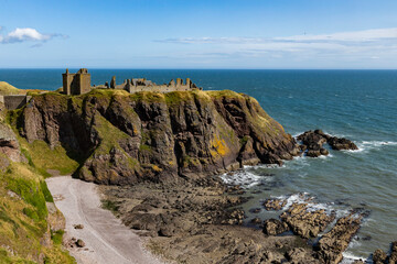 Dunnottar Castle rises in dramatic ruins atop a cliff overlooking the North Sea. Its breathtaking views, rich history, and rugged beauty make it one of Scotland’s most iconic and cinematic locations