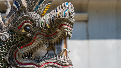 Ornate serpent statue with colourful detailing at temple entrance