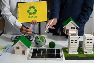 Two colleagues discussing data sustainable development with renewable energy solutions, ecology...