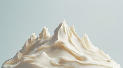 A cake styled as a minimalist mountain range with textured frosting peaks 