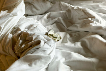 Crumpled white bed sheets with scattered dollar bills on top, New Orleans, USA