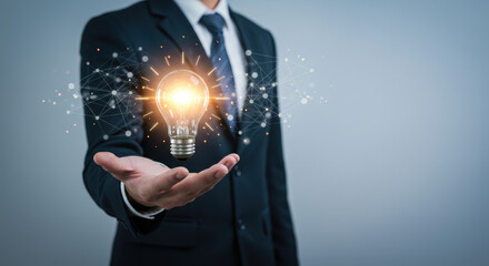  Innovation Spark: Businessman Holding a Bright Idea Bulb for Creative Solutions & Strategic Thinking in Business