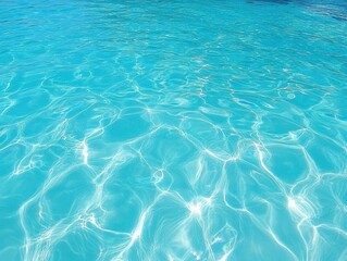 Obraz premium Serene turquoise water surface with sun reflections creating a tranquil and refreshing visual mood perfect for summer vacation