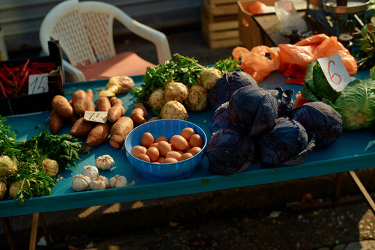 Fresh produce displayed on a market table including eggs, sweet potatoes, and purple cabbage. Split, Croatia