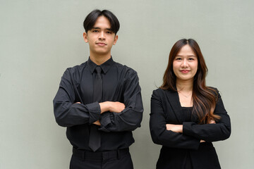 Portrait of young Asian couple wearing business uniform
