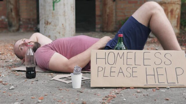 Homeless man with a sign please help dreams of his own house. Concept of unemployment and crisis.	
