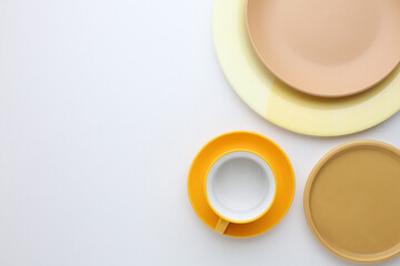 Beautiful multi-coloured bright ceramic bowl and tarenes, on a table top view
