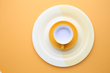 Beautiful multi-coloured bright ceramic bowl and tarenes, on a table top view