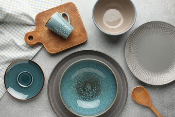 Set of kitchenware on grey marble table near light wall. Modern interior design
