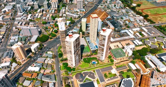 Few high-rise buildings stand out at the landscape of low rise area. Panorama of Honolulu, Hawaii, USA from top view.
