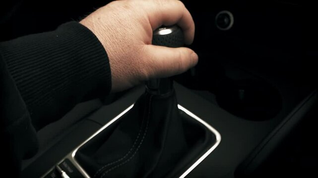 Male hand changing manual gear lever in a car stock footage