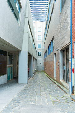 Looking down a narrow alley with high cements walls on both sides