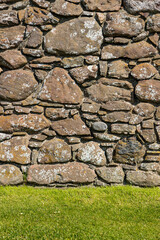 An ancient medieval brick wall tells stories of the past. Its worn textures and weathered details evoke legends and mysteries held within the stones over centuries