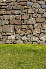 An ancient medieval brick wall tells stories of the past. Its worn textures and weathered details evoke legends and mysteries held within the stones over centuries