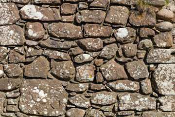 An ancient medieval brick wall tells stories of the past. Its worn textures and weathered details evoke legends and mysteries held within the stones over centuries