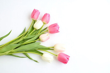bunch of pink and white tulips on a white surface