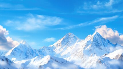 Obraz premium Majestic Snowy Mountains Under Bright Blue Sky with Soft Clouds