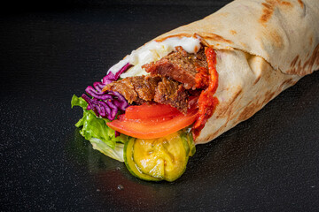 Savor a tasty wrap packed with grilled meat, vibrant veggies, and zesty sauces!