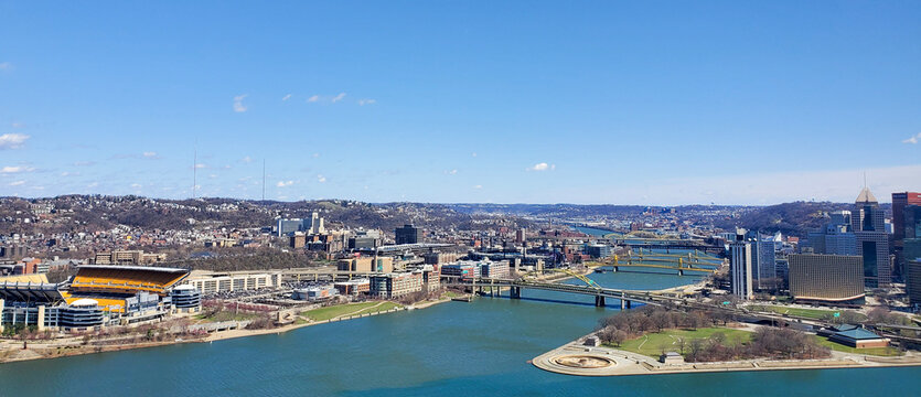 Pittsburgh, Pennsylvania, USA &ndash; April 10, 2024: Panoramic view of Point State Park where the Allegheny and Monongahela Rivers meet to form the Ohio River, with Acrisure Stadium and downtown in view.