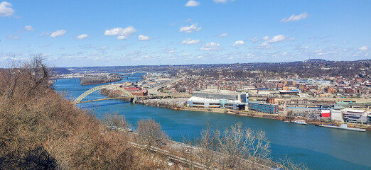 Pittsburgh, Pennsylvania, USA – April 10, 2024: Panoramic view of Point State Park where the Allegheny and Monongahela Rivers meet to form the Ohio River, with Acrisure Stadium and downtown in view.